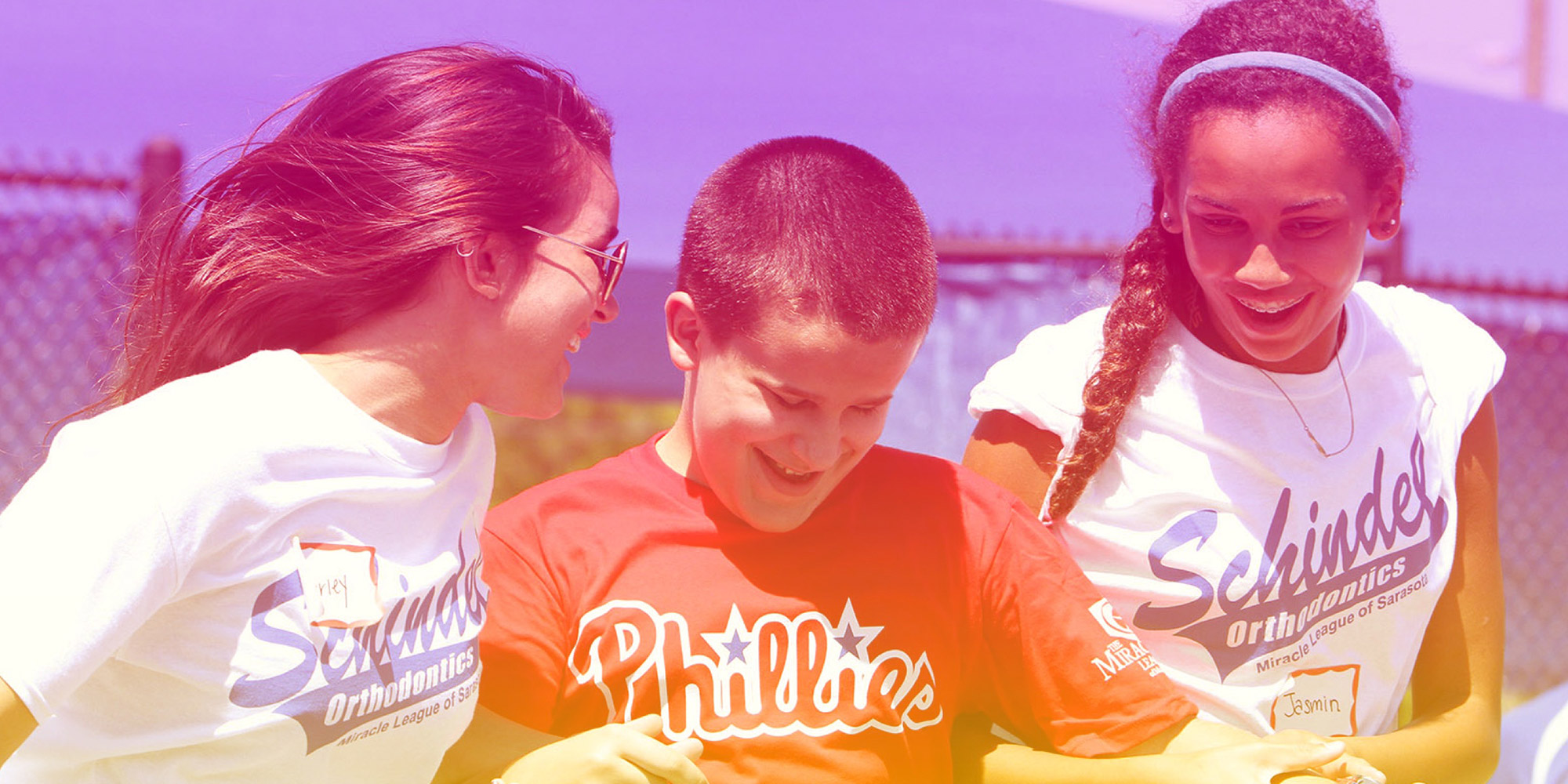 A player and two assistants gleefully round the bases